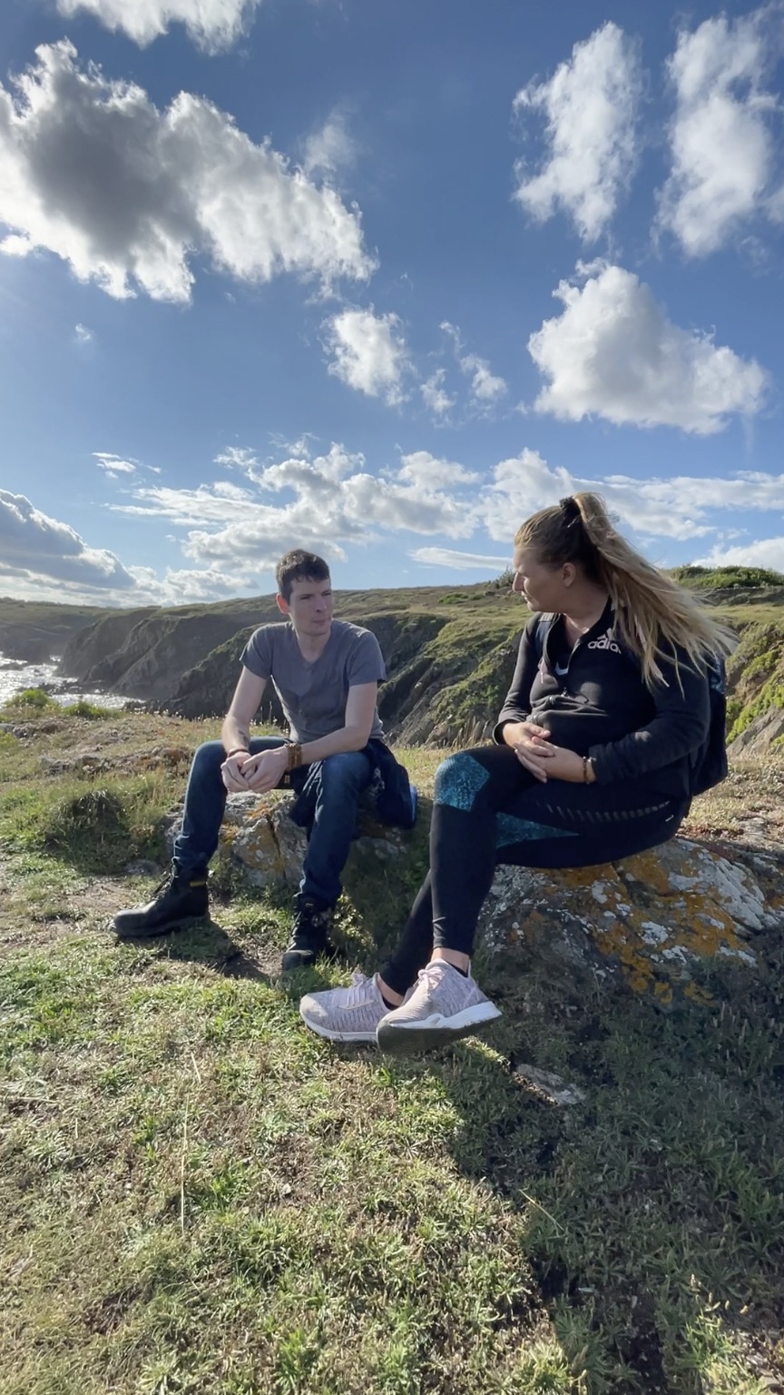 Laëtitia en échange assise en extérieur avec un client, Bretagne